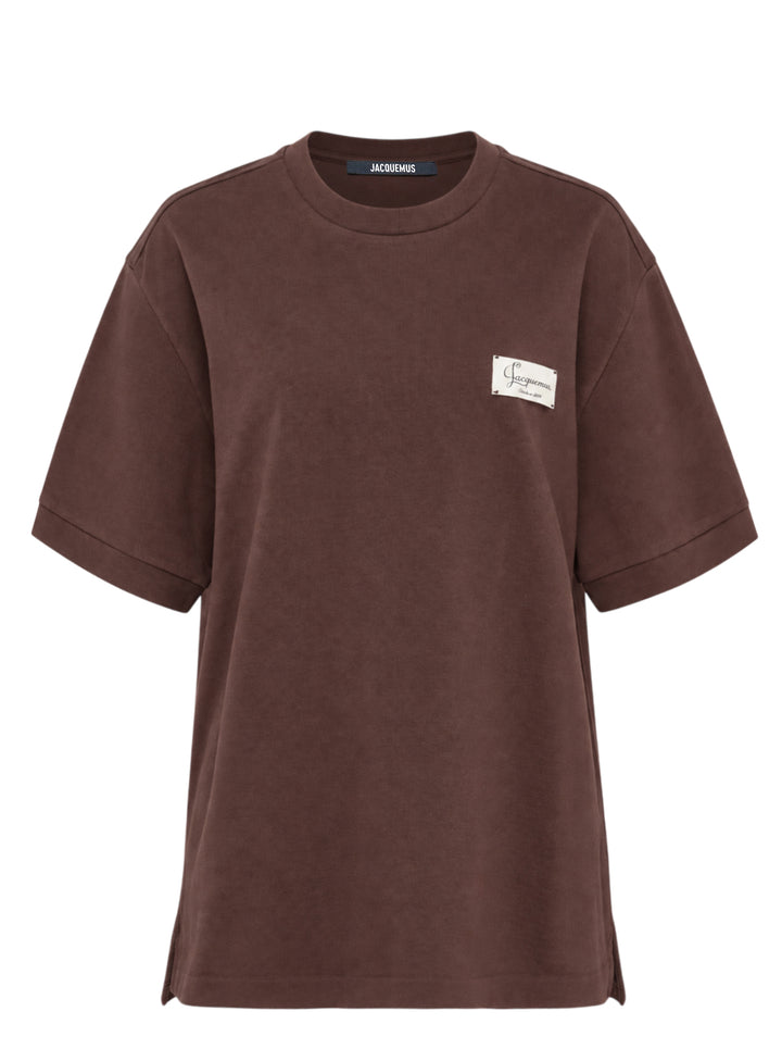 Jacquemus Le Montaigne oversized short sleeve tee in chocolate brown with woven script label on the chest