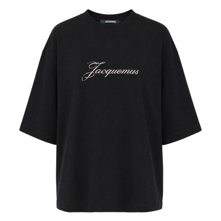 Jacquemus black oversized short-sleeve t-shirt with embroidered cursive logo across the chest and ribbed crew neckline, displayed on a white background