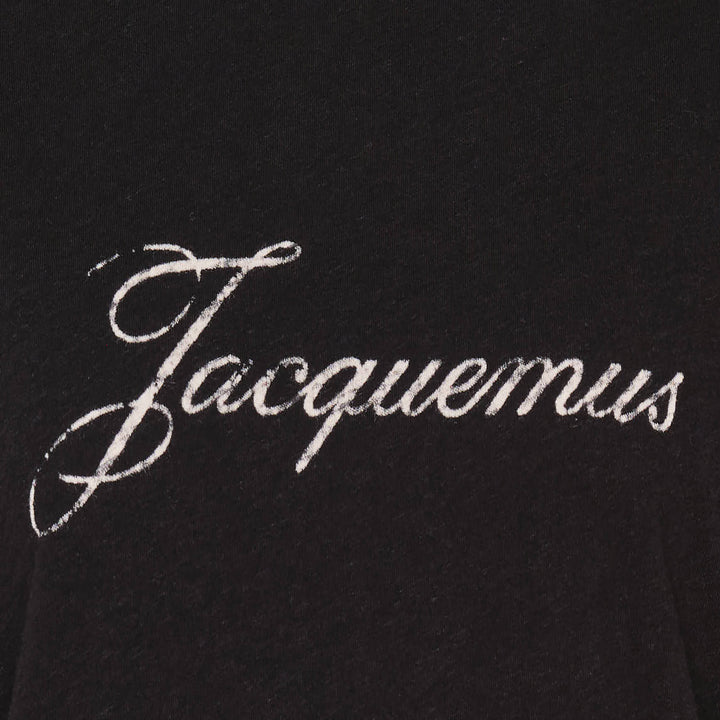 Jacquemus black oversized short-sleeve t-shirt with embroidered cursive logo across the chest and ribbed crew neckline, displayed on a white background - view 4