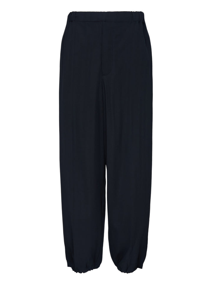 Jacquemus Gio navy trousers with an elasticated waist, relaxed wide leg and gathered cuffs, shown from the front