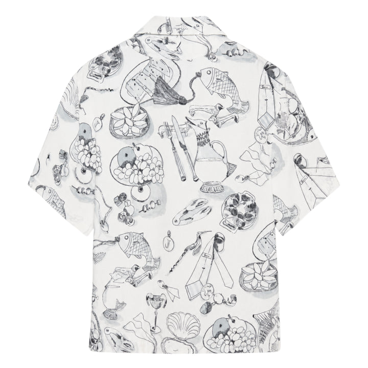 Jacquemus La Chemise Cocktail short sleeve shirt in white with an all-over monochrome hand-drawn still-life sketch print featuring shells, fish, fruit, and ribbon motifs, camp collar, and button-through front fastening - view 2