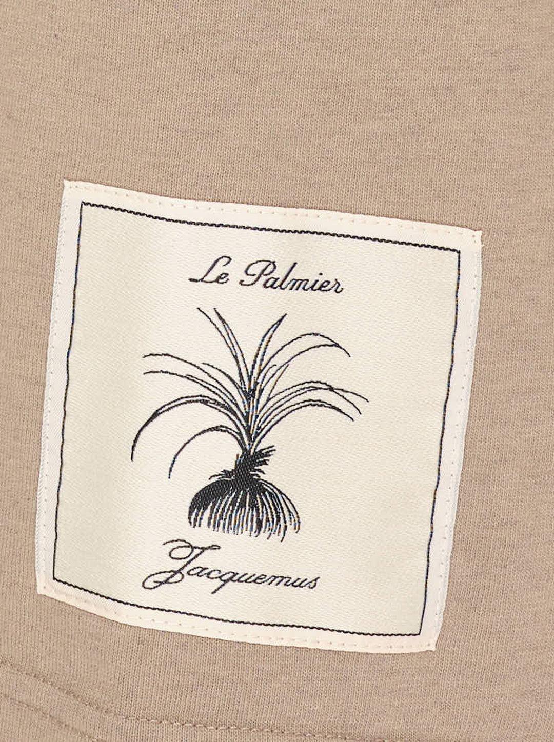 Jacquemus Le T-shirt Torneo short sleeve tee in taupe with a woven botanical label at the hem - view 3