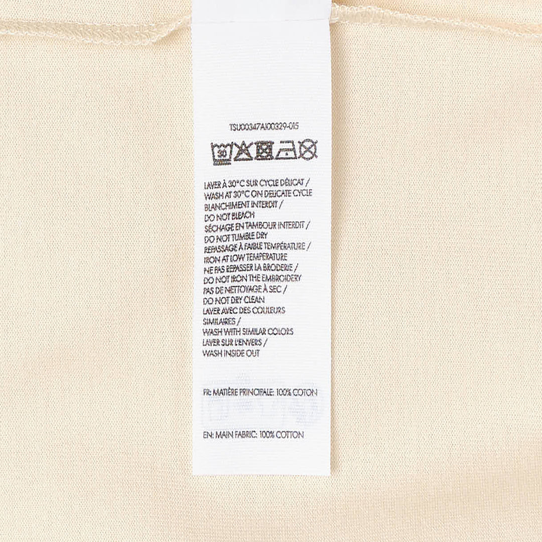 Jacquemus Le T-Shirt Bichon in ecru — long-sleeve crew-neck tee featuring a tonal brown hand-drawn curly dog illustration with a varsity number bib and cursive Jacquemus script across the front - view 3