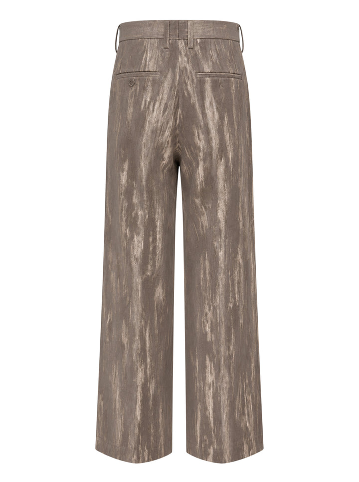 doublet Dust Flocky Trousers in a mottled earthy brown abstract print, featuring wide-leg cut with front pleats and embroidered graphic at the hem, displayed flat on white background - view 2