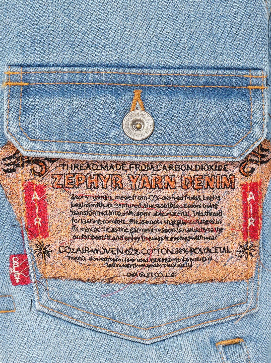 doublet Air Yarn Faded Denim Jacket in light-wash blue with archival printed patch labels on the chest pocket and cuff, featuring amber topstitching and gunmetal button fastening - view 3
