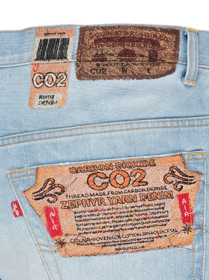 doublet Air Yarn Faded Wide-Leg Jeans in light wash blue, front view showing high-rise waist, five-pocket detail, and exaggerated wide leg silhouette with contrast orange topstitching - view 3