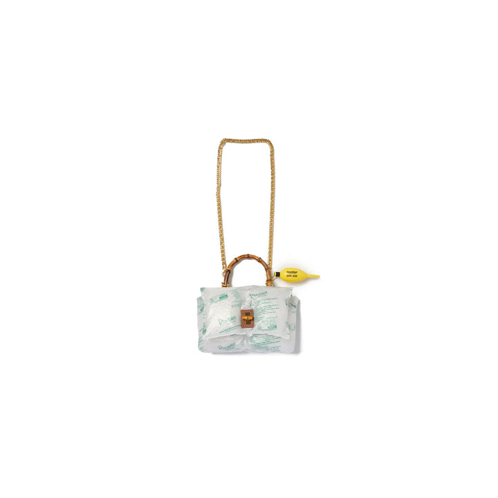 doublet Air Pillow Bamboo Handle Bag wrapped in inflatable air cushions with a gold chain strap, bamboo handle, tan leather turn-lock and yellow air pump charm