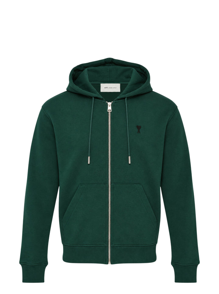 AMI Alexandre Mattiussi forest green zip hoodie with embroidered Ami de Cœur heart logo on the chest, full-length silver zip, kangaroo pocket, and adjustable tonal drawstring hood