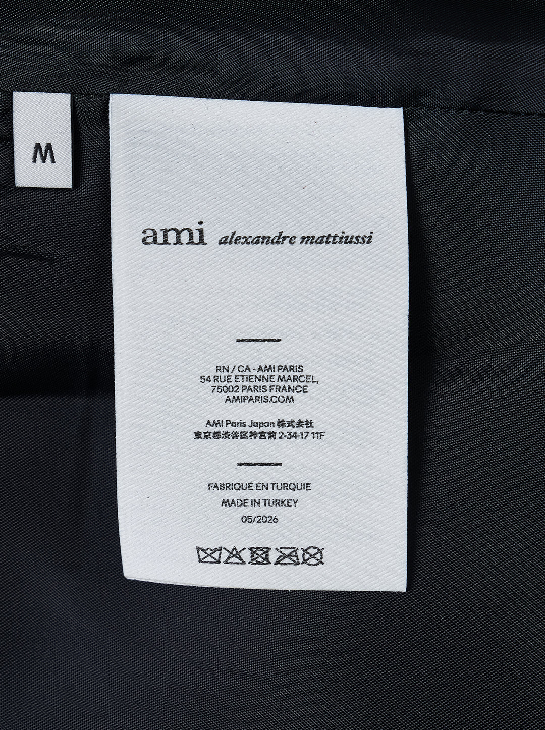 AMI black leather zipped jacket with pointed collar, dual-zip front closure and slanted welt pockets, shown from the front - view 4