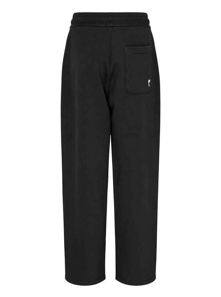 AMI black drawstring sweatpants with ribbed waistband and wide straight leg, shown from the front - view 2