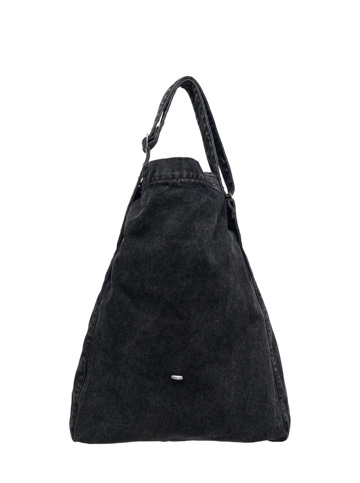 Our Legacy washed black denim sling crossbody bag with adjustable strap and drawstring top closure, rear view