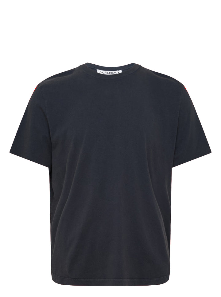 Our Legacy Box Short Sleeve Tee in washed navy with contrast red shoulder tape and woven brand label at the back neck, displayed front-facing on a white background