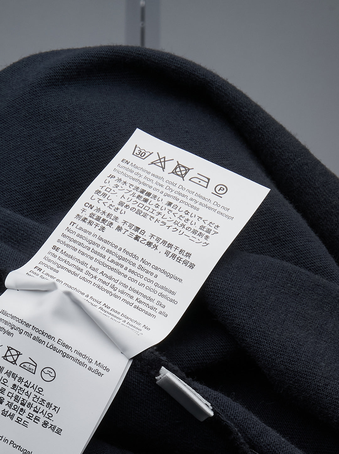 Our Legacy Box Short Sleeve Tee in washed navy with contrast red shoulder tape and woven brand label at the back neck, displayed front-facing on a white background - view 3