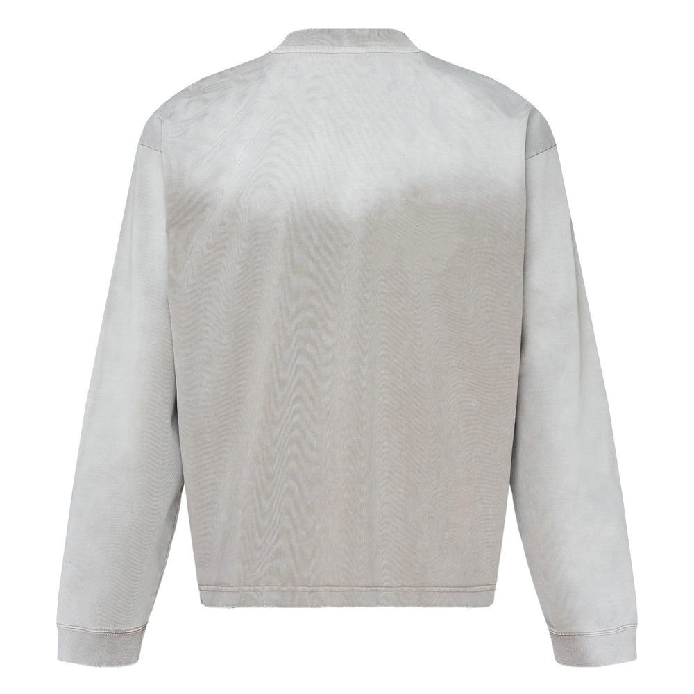 Mihara Yasuhiro Distressed Long Sleeve Tee in washed grey with chest patch pocket, mottled aged texture, and branded information label on the front hem - view 2