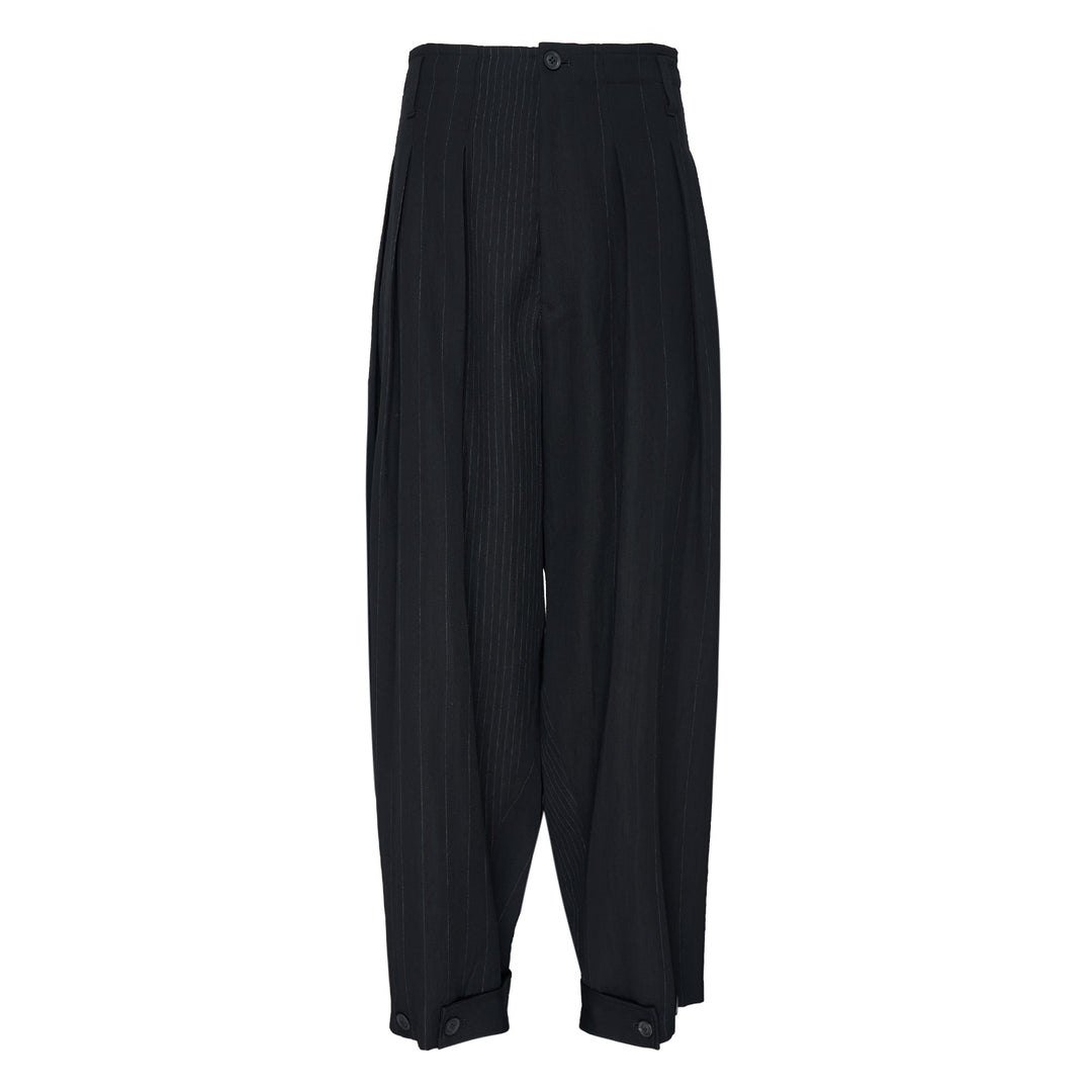 Yohji Yamamoto Hem Tab Wide Tuck Pants in black pinstripe, featuring a high-rise waistband, deep forward pleats, voluminous wide-leg silhouette, and buttoned cuff tab detailing at the hem