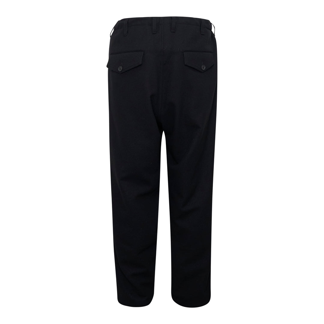 Yohji Yamamoto Hem Slit Button Pants in black, featuring tonal button-detailed hem slits at both ankles and side patch pockets with button-tab hardware, cropped tailored silhouette on white background