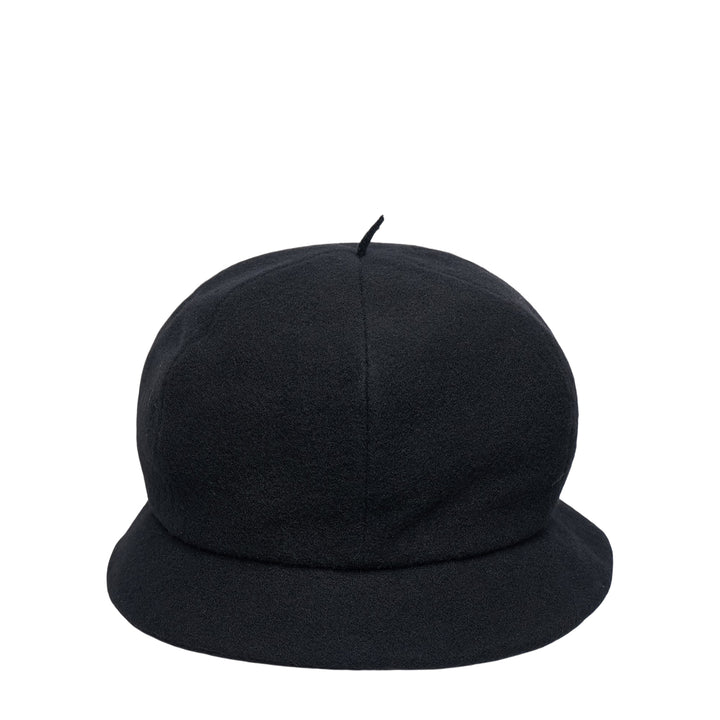 Y's black wool beret cap with a rounded dome crown, small fabric pip at the apex, and a soft downward-curved unstructured brim, photographed on a white background