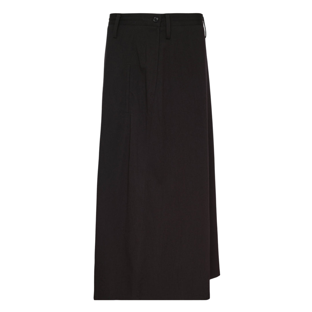 Y's black structured cloth maxi skirt with asymmetric hem, patch pocket, and tailored waistband with button fastening