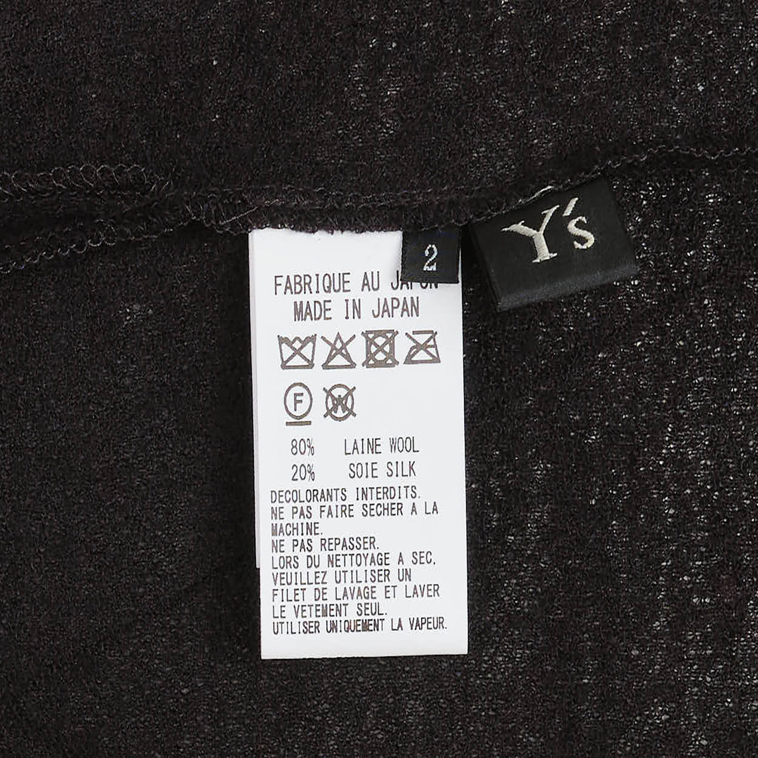 Y's black long-sleeve crew-neck knit top with asymmetric draped panel, vertical shell buttons, and adjustable drawstring tie creating a ruched sculptural effect - view 3