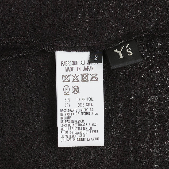 Y's black long-sleeve crew-neck knit top with asymmetric draped panel, vertical shell buttons, and adjustable drawstring tie creating a ruched sculptural effect - view 3