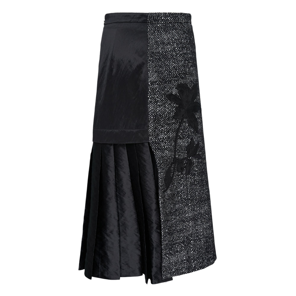 Erdem Salt & Pepper Wool Midi Skirt featuring asymmetric salt-and-pepper tweed and black nylon panels with a pleated hem, on a white background
