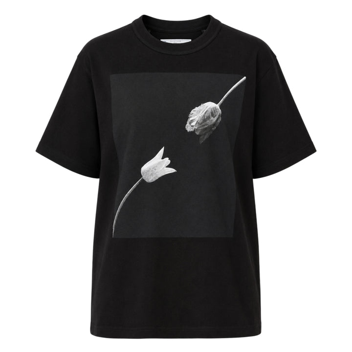 sacai Robert Mapplethorpe Graphic Tee in black, featuring a square monochrome photographic print of two tulips — one in bloom and one wilting — on the chest, with a relaxed boxy fit and crew neckline
