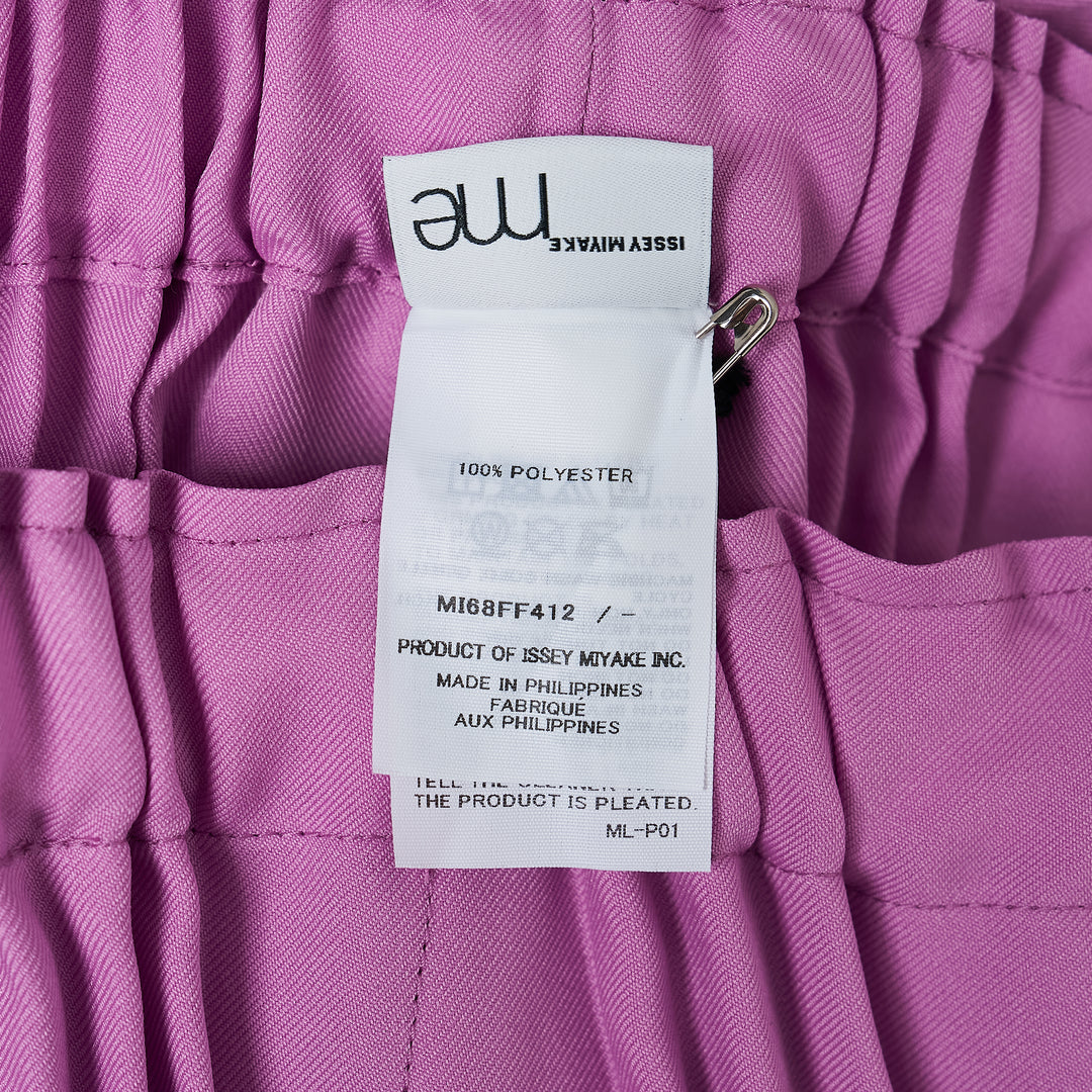 me Issey Miyake Tower Pleats Bottom in black — wide-leg cropped pants with deep vertical pleating and elasticated waistband, shown flat on white background