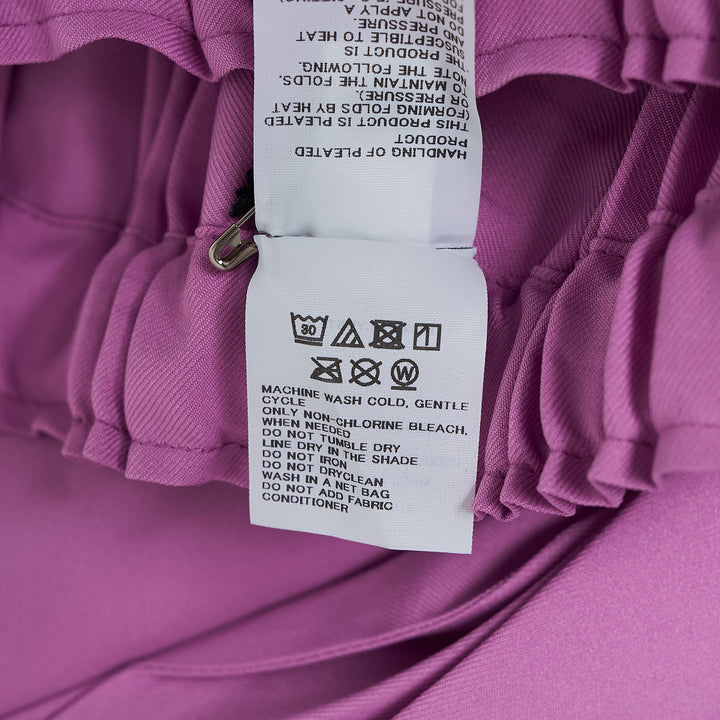 me Issey Miyake Tower Pleats Bottom in black — wide-leg cropped pants with deep vertical pleating and elasticated waistband, shown flat on white background