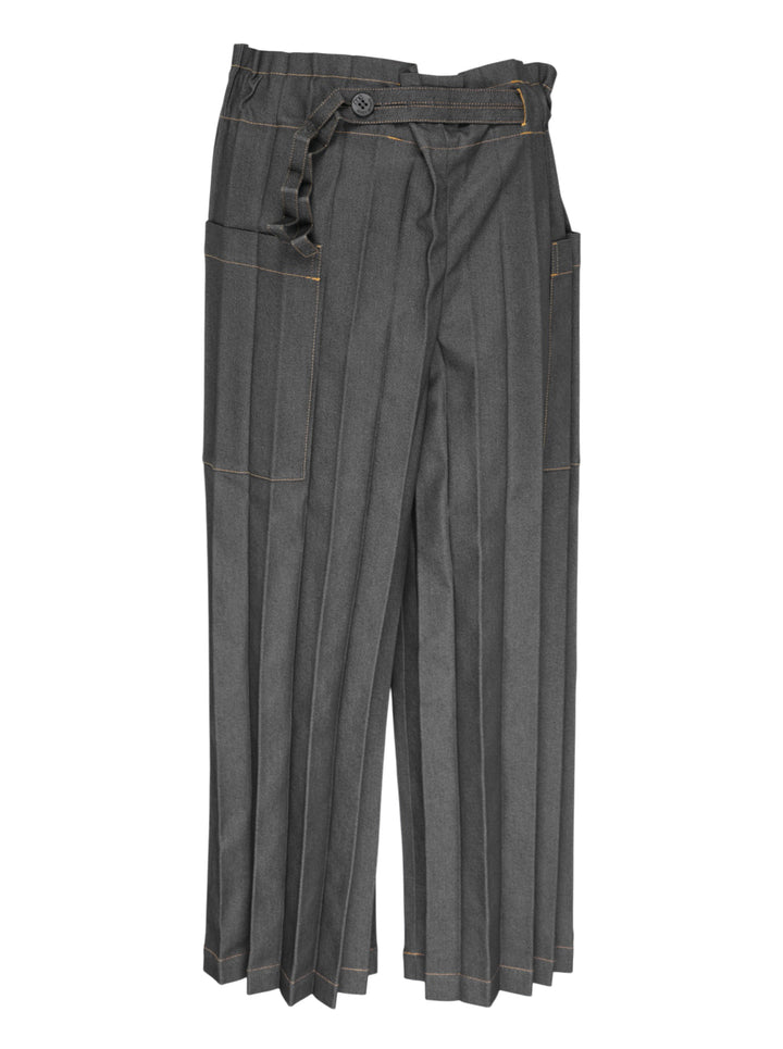 me Issey Miyake Denim Pleats Bottom in grey — wide-leg pleated pants with contrast amber topstitching, asymmetric wraparound waistband, single button closure, and patch pockets