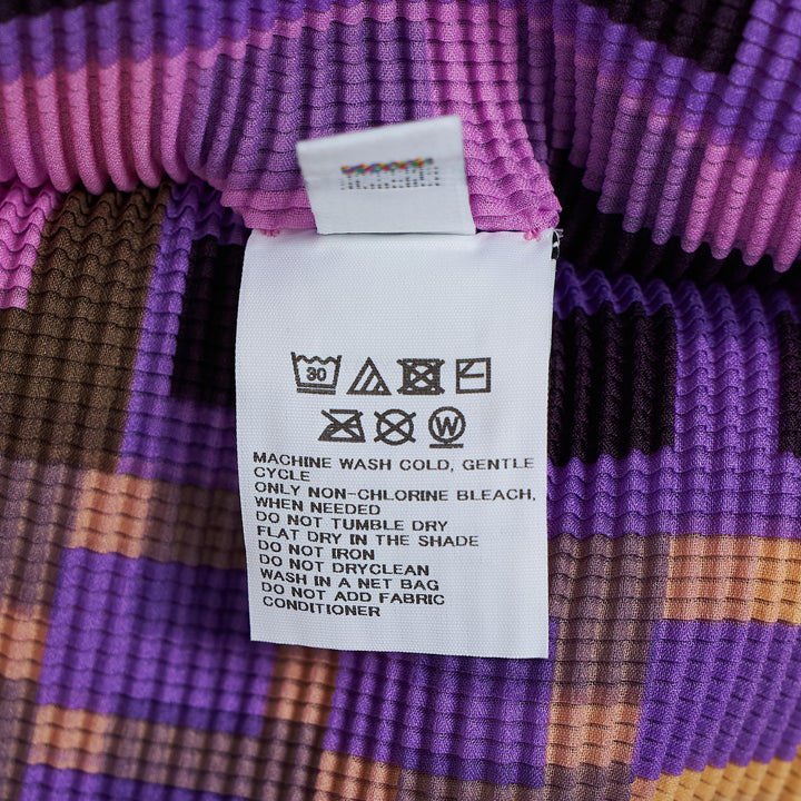 me Issey Miyake Building Short Sleeve Pleated Top with allover monochromatic cityscape and botanical graphic print