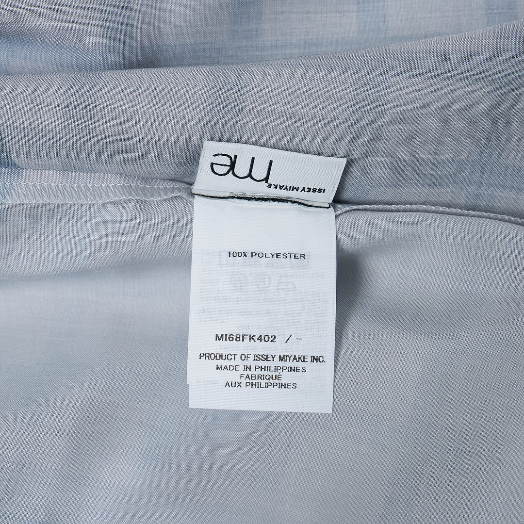 me Issey Miyake Building Print Cap Sleeve Top featuring an all-over graphic print of silhouetted urban buildings and botanical foliage in black, white, and muted violet-grey, shown from the front against a white background