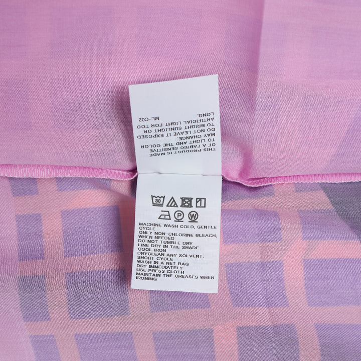 me Issey Miyake Building Print Cap Sleeve Top featuring an all-over graphic print of silhouetted urban buildings and botanical foliage in black, white, and muted violet-grey, shown from the front against a white background