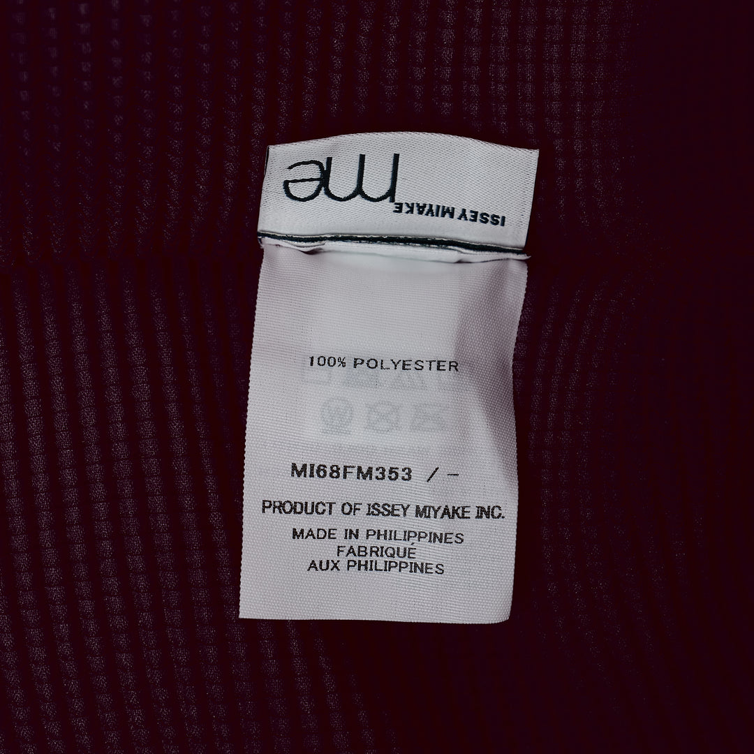 me Issey Miyake Stretch Pleats 2 sleeveless top in deep burgundy, featuring all-over micro-pleated texture, a high stand collar with centre V-notch, and a broad structured shoulder line