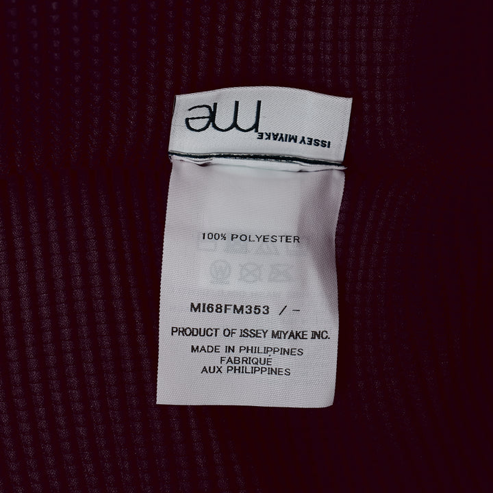 me Issey Miyake Stretch Pleats 2 sleeveless top in deep burgundy, featuring all-over micro-pleated texture, a high stand collar with centre V-notch, and a broad structured shoulder line