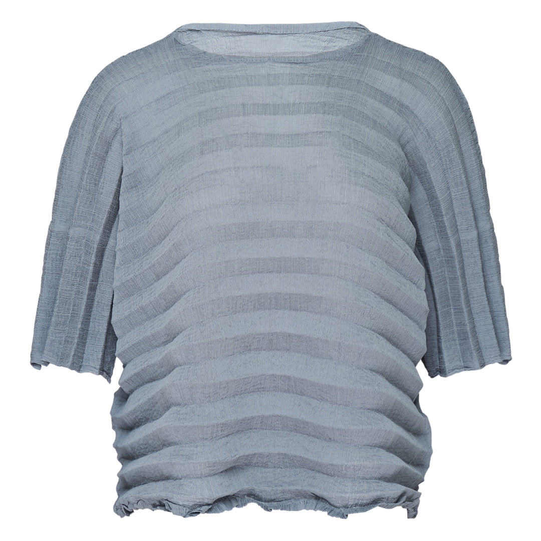 me Issey Miyake Accordion See-Through Crepe top in dusty blue, featuring horizontal accordion pleating, oversized boxy silhouette, elbow-length sleeves, and a gathered ruched hem, photographed flat on a white background