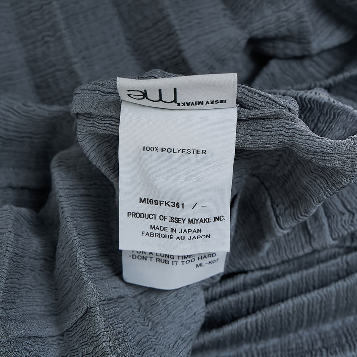 me Issey Miyake Accordion See-Through Crepe top in dusty blue, featuring horizontal accordion pleating, oversized boxy silhouette, elbow-length sleeves, and a gathered ruched hem, photographed flat on a white background