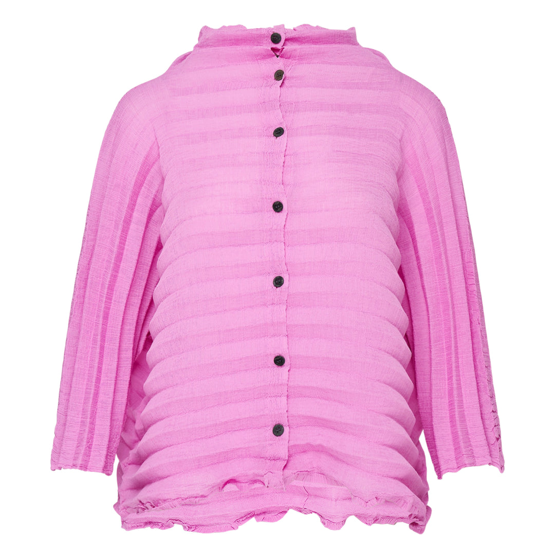 me Issey Miyake Accordion See-Through Crepe Cardigan in pink, featuring horizontal accordion pleating, ruffled lettuce-edge trim, dark contrast button-through front, and a relaxed long-sleeve silhouette