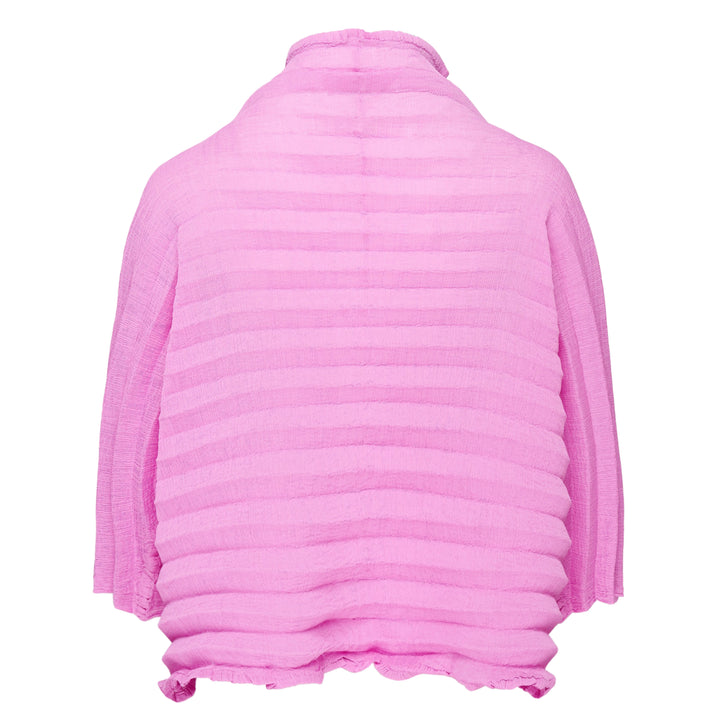 me Issey Miyake Accordion See-Through Crepe Cardigan in pink, featuring horizontal accordion pleating, ruffled lettuce-edge trim, dark contrast button-through front, and a relaxed long-sleeve silhouette