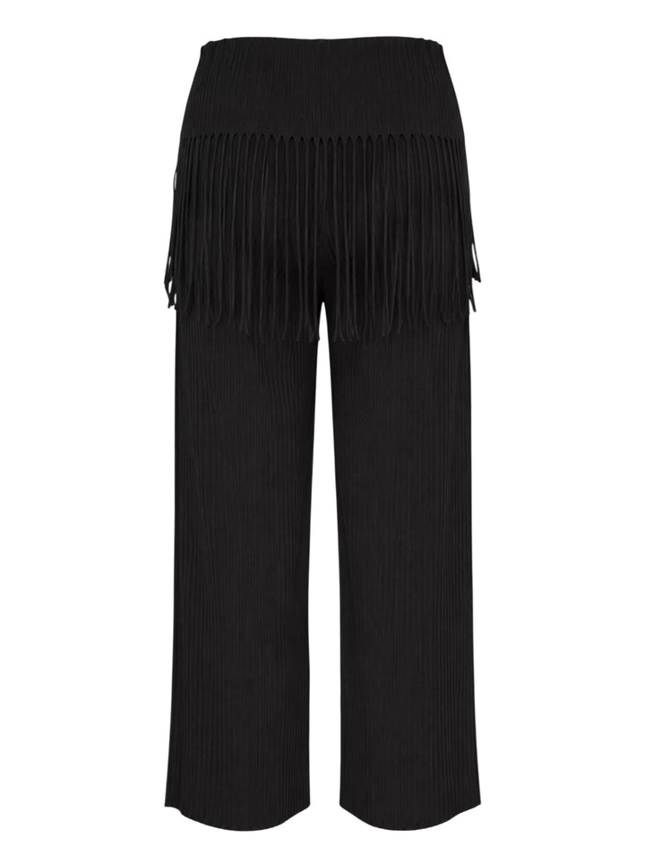 me Issey Miyake Leaf Pleats Pants in black — rear view showing wide-leg pleated silhouette with dramatic fringe trim at the hip yoke and elasticated waistband