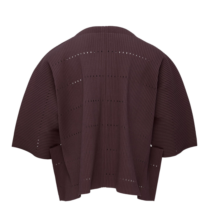 me Issey Miyake Tower Pleats Cardigan in cobalt blue, back view, featuring radiating openwork cutouts, tonal buttons, patch hip pockets, and cropped elbow-length sleeves