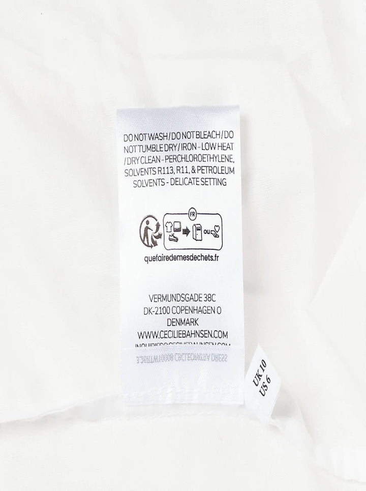 Cecilie Bahnsen Cleopatra Floratini midi dress in white textured jacquard with short puff sleeves, sculpted bodice, and full flared skirt, shown on a plain white background - view 4