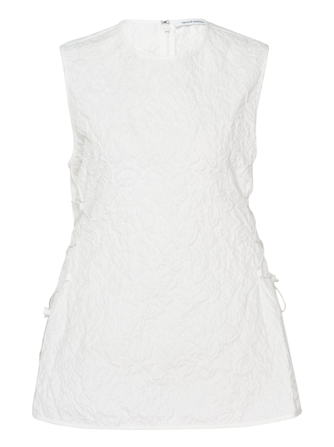 Cecilie Bahnsen Floratini Matelassé sleeveless top in white, shown from the back, featuring an all-over raised floral quilted pattern, gathered bow details along both side seams, and a concealed back zip closure