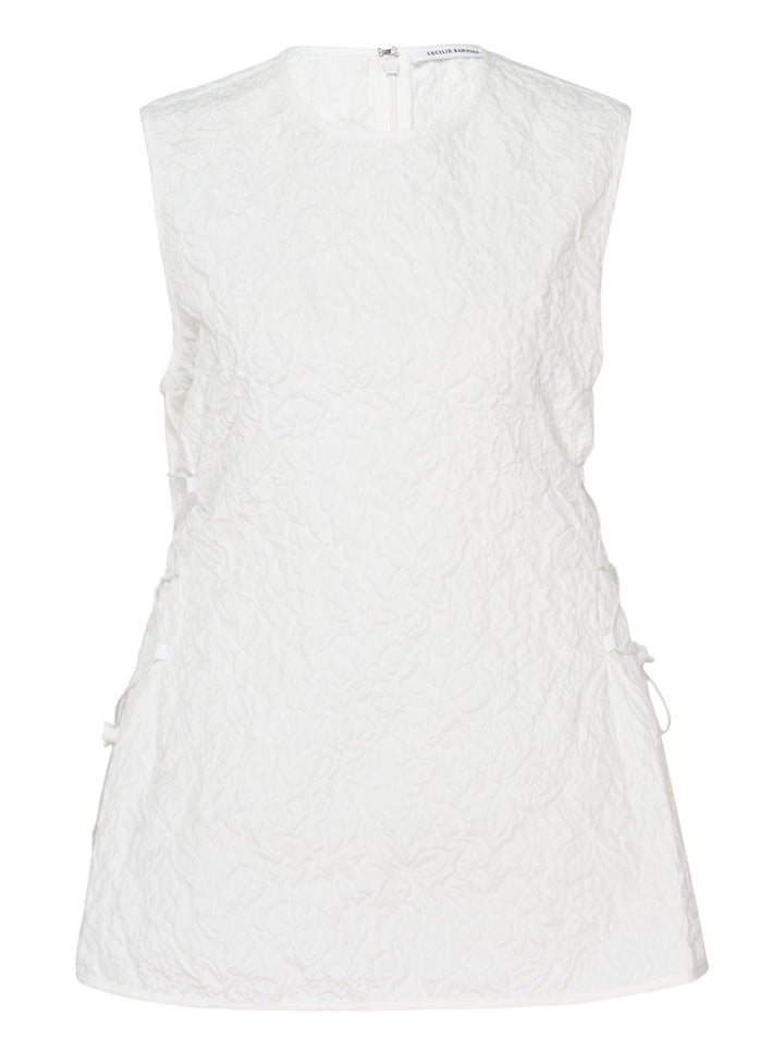 Cecilie Bahnsen Floratini Matelassé sleeveless top in white, shown from the back, featuring an all-over raised floral quilted pattern, gathered bow details along both side seams, and a concealed back zip closure