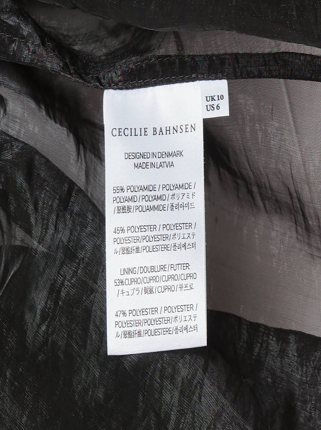 Cecilie Bahnsen Liquid Myrtia short-sleeve peplum top in black crinkled organza with sheer sleeves and gathered ruffle hem, photographed flat on a white background - view 3