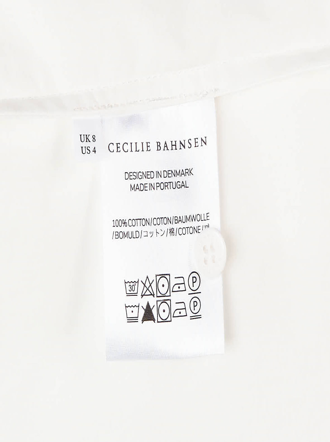 Cecilie Bahnsen Frina cropped white cotton shirt with bow-tied flared cuffs, tonal floral embroidered chest pocket, and button-through front placket, displayed flat on a white background - view 3