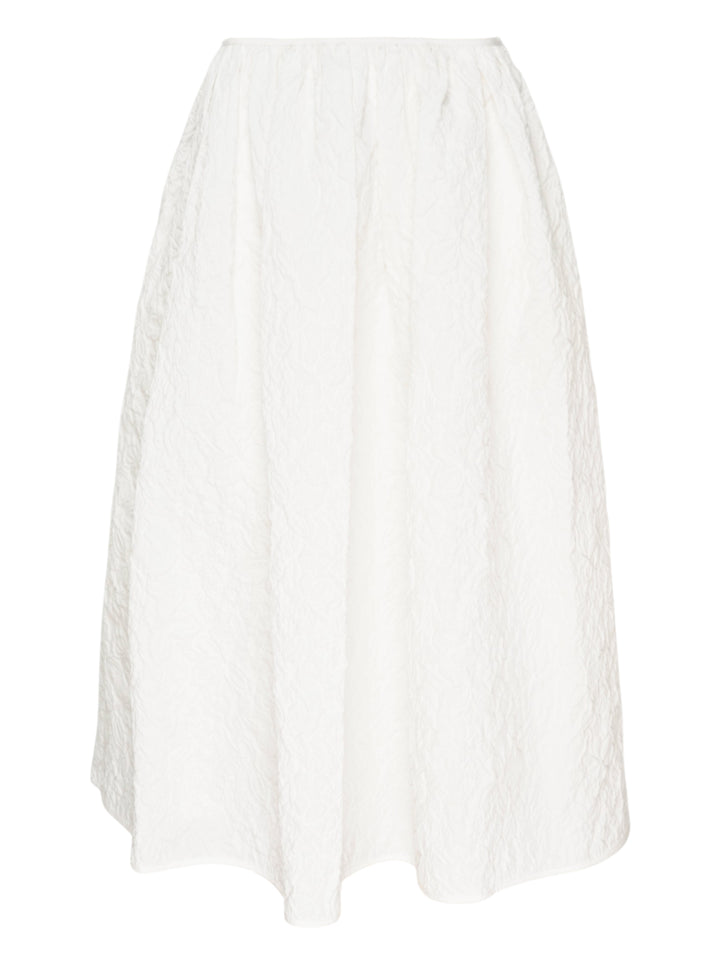 Cecilie Bahnsen Floratini Matelassé Midi Skirt in white, displayed flat, showing a voluminous A-line silhouette with an all-over raised jacquard texture and elasticated waistband