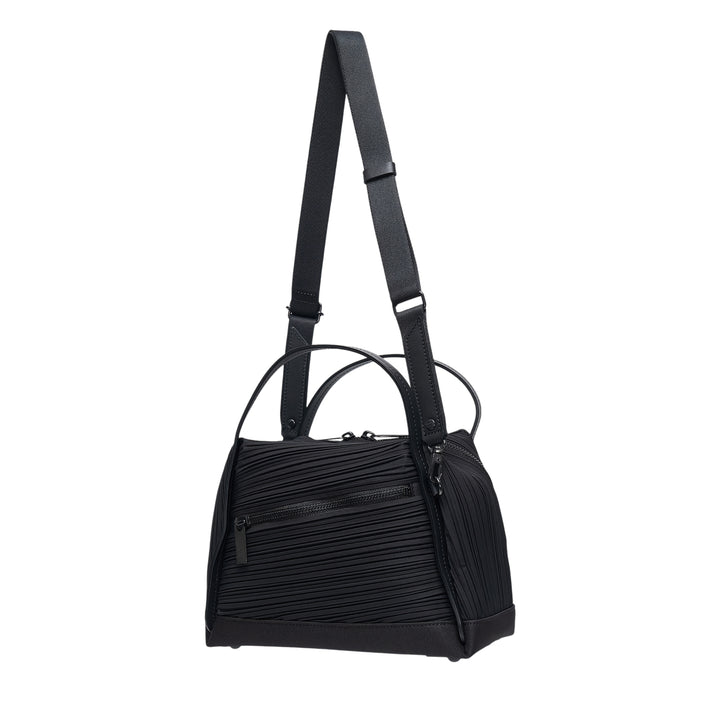 Pleats Please Issey Miyake Bias Pleats Crossbody Bag in black, showing diagonal pleated fabric body, dual top handles, and adjustable webbing shoulder strap on white background