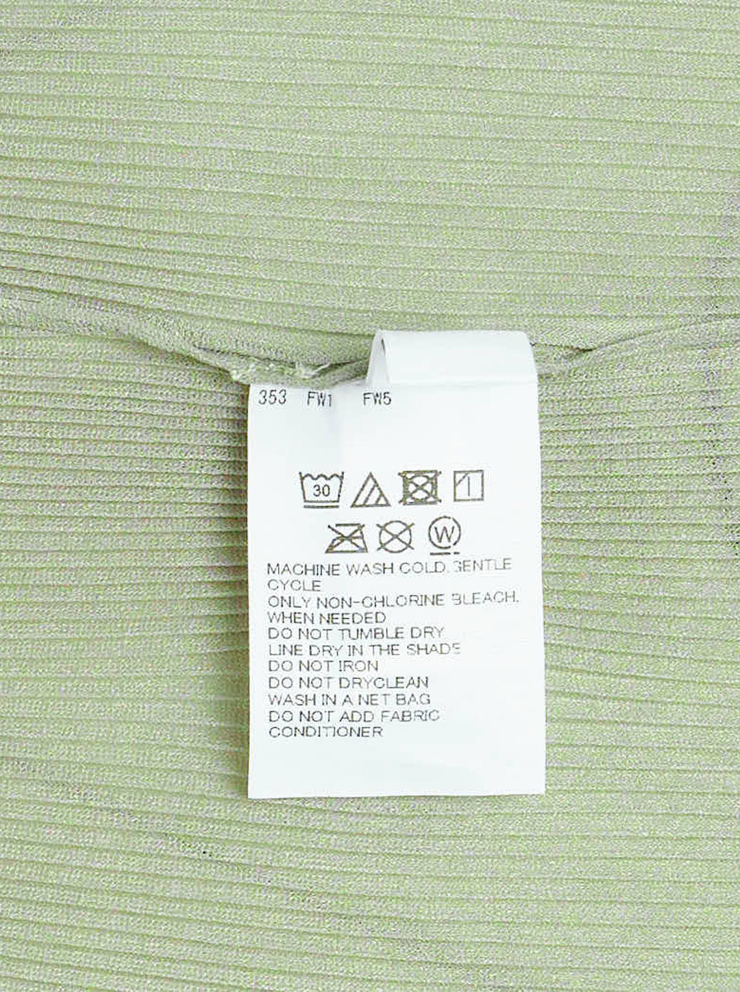 Pleats Please Issey Miyake Mist September fitted cap sleeve top in sage green with fine pleated ribbed texture and ruffled sleeve edges, photographed on a ghost mannequin against a white background - view 3