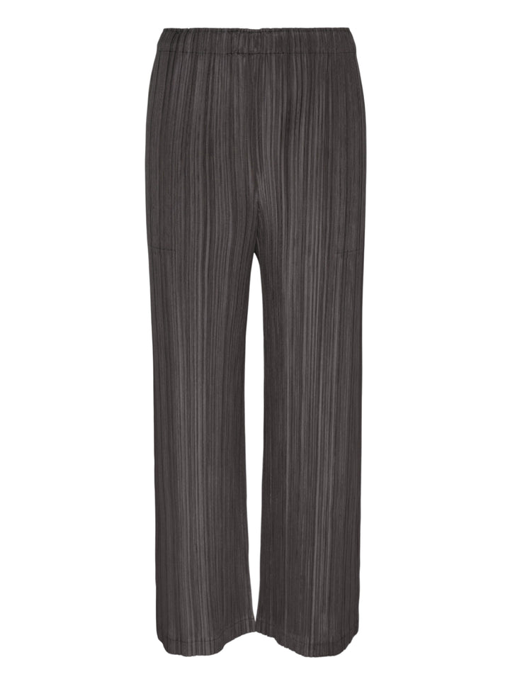 Pleats Please Issey Miyake Thicker Bottoms 2 wide-leg pleated trousers in charcoal grey with vertical plissé texture and elasticated waistband, front view