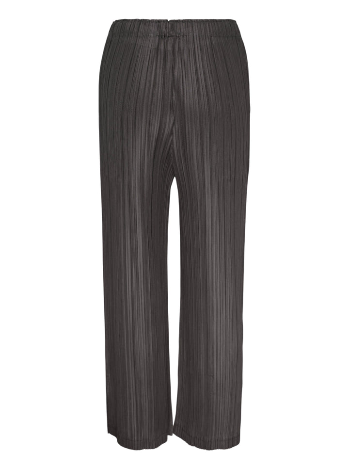 Pleats Please Issey Miyake Thicker Bottoms 2 wide-leg pleated trousers in charcoal grey with vertical plissé texture and elasticated waistband, front view - view 2